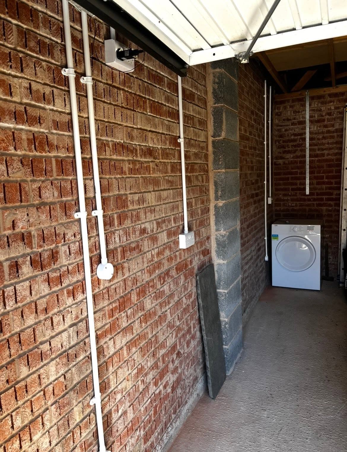 Garage rewired with surface conduit, sockets, a junction box and a garage door opener supply